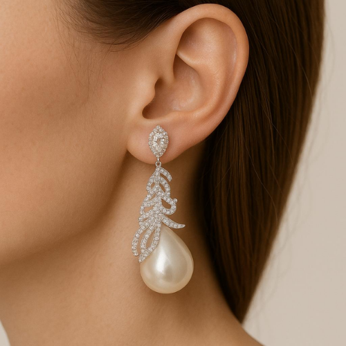 Luxurious earrings with a delicate leaf design and a large pearl