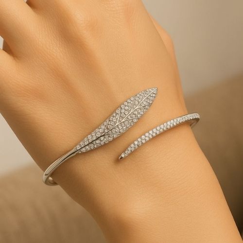 Elegant women's bracelet - open leaf design adorned with delicate crystals