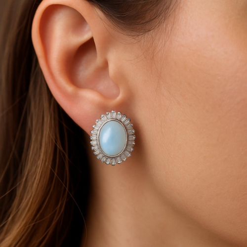 Soft earring with an oval blue stone and luxurious setting