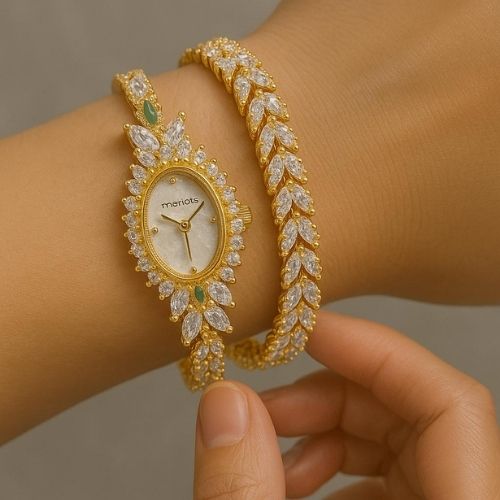 Merlots gold watch - oval design studded with white and green zircons